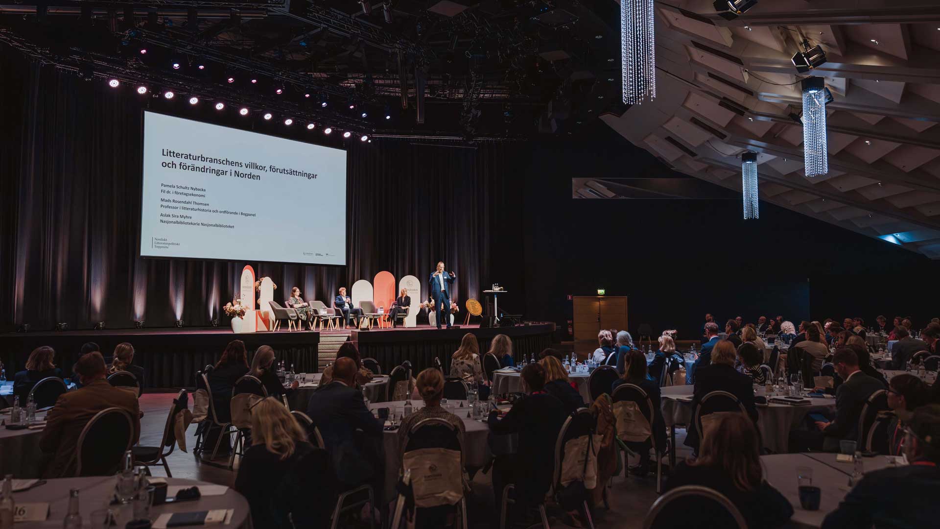 a stage and and audience at a summit